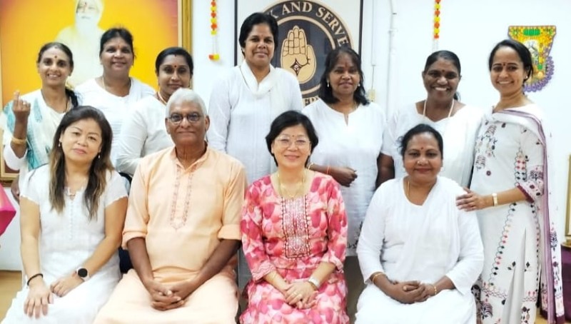 Group photo of Tera Mai™ Reiki practitioners and students in Kuala Lumpur, including Master Jay Shiva and other women dressed in traditional white attire, smiling after a Reiki training session.